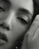 Black & white close up video of a model with defined curly hair