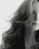 Black & white close-up video of a model with a voluptuous blowout 