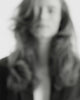 Black & white video of a model with a bouncy, voluptuous blow-out walking towards the camera
