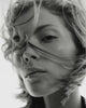 Black & white close-up video of a model with a straigh bob, hair blowing across her face